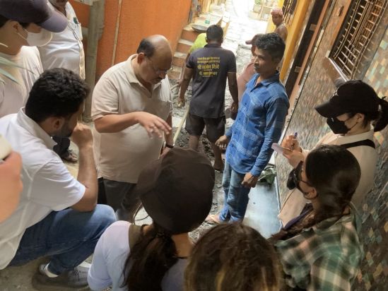 urbz team and NYU AD students on site with the community leaders