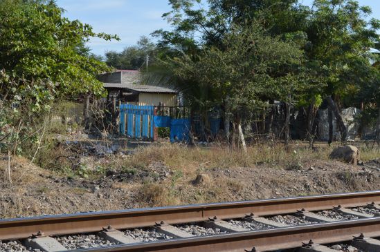 Residences and stores located adjacent to the railway track in the city.