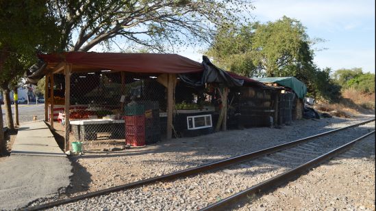 Residences and stores located adjacent to the railway track in the city.