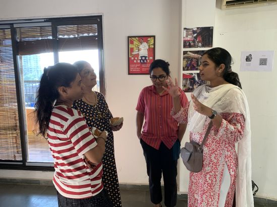   Samya Korde speaking with locals at the Homegrown street exhibition 