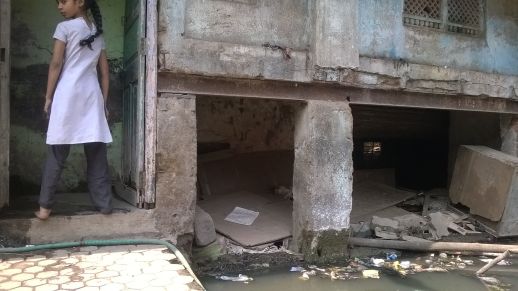 Roads have been laid several time over the past decades and eventually rose above the level of old houses, making them look as if they had sank into the ground.