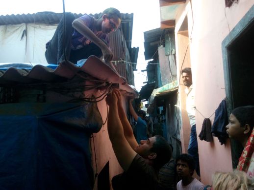 Students from NYU, Abu Dhabi campus, implementing a design they made for a roofing system that they studied for a week in Dharavi