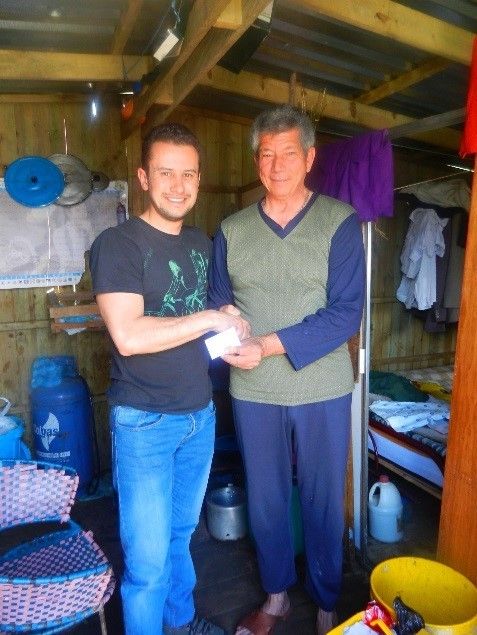 Andres with friends in a home in Ciudad Bolivar