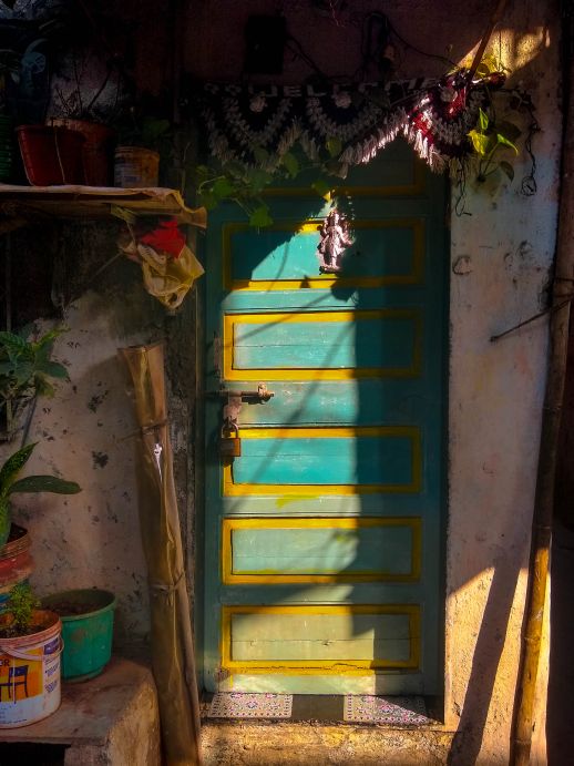 The doorways are adorned with hand-woven torans