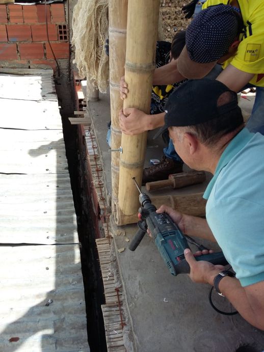 Construction of bamboo structure by the community in Cazuca, Bogota