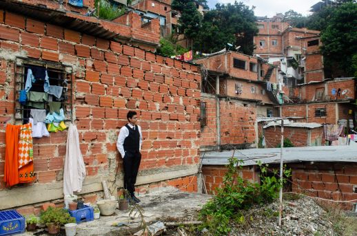 A resident outside the home he built in Barrio San Blas, Petare