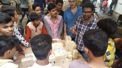 Jai Bhadgaonkar presenting a wood model of the area to residents.