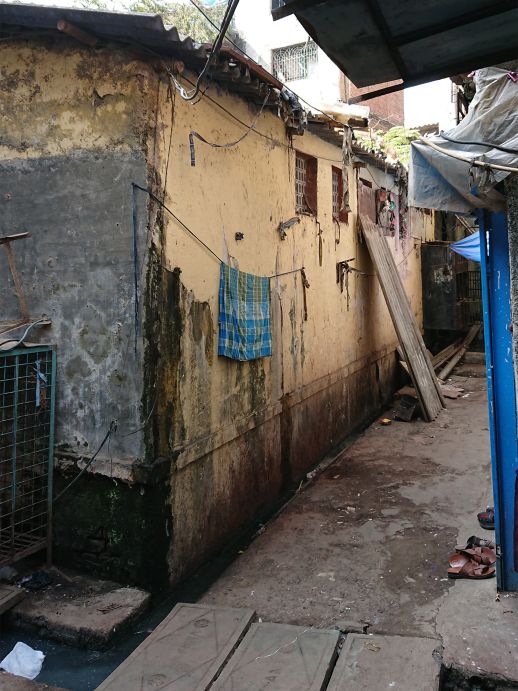 Passage to the north of the toilet block that connects to the main road