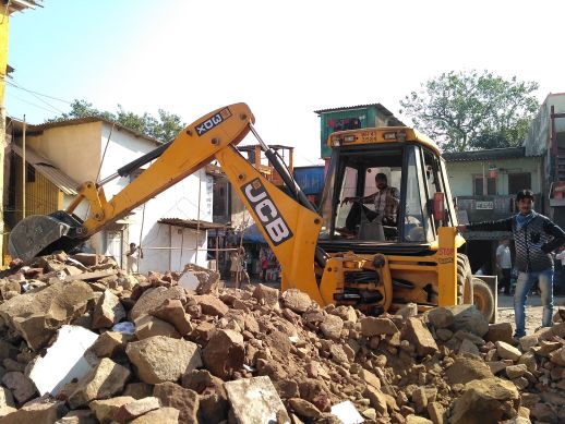 Demolition workers with their JCB