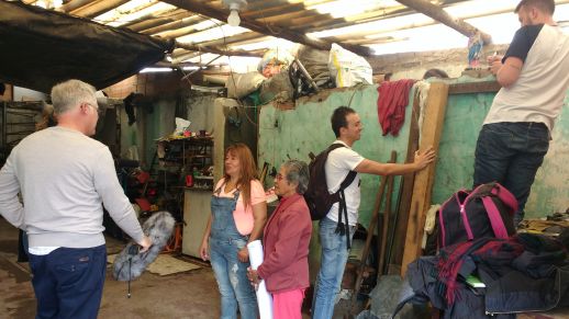 urbz team members, Jairo and Remi, measuring the site