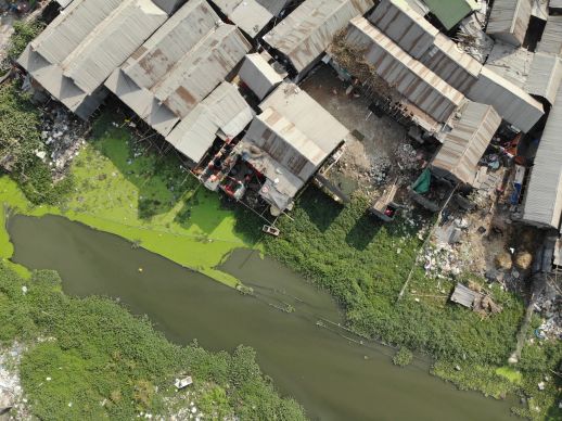 Infilled land near the water body within the settlement
