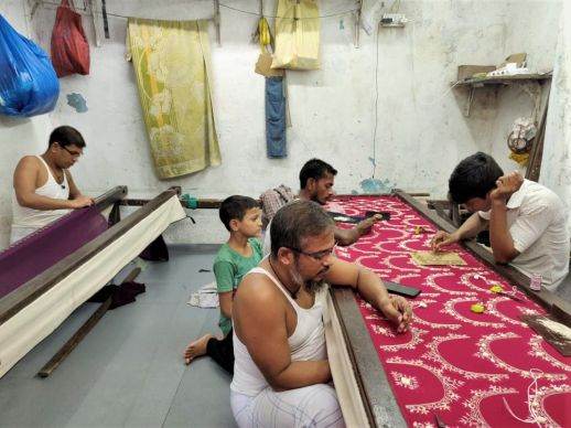 Three people working on one frame at a time.